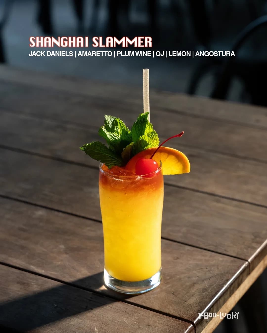 A 1-800-Lucky 'Shanghai Slammer' cocktail card — a mango-orange highball with mint, an orange wheel, and a cherry, listing Jack Daniel's, amaretto, plum wine, OJ, lemon, and Angostura.