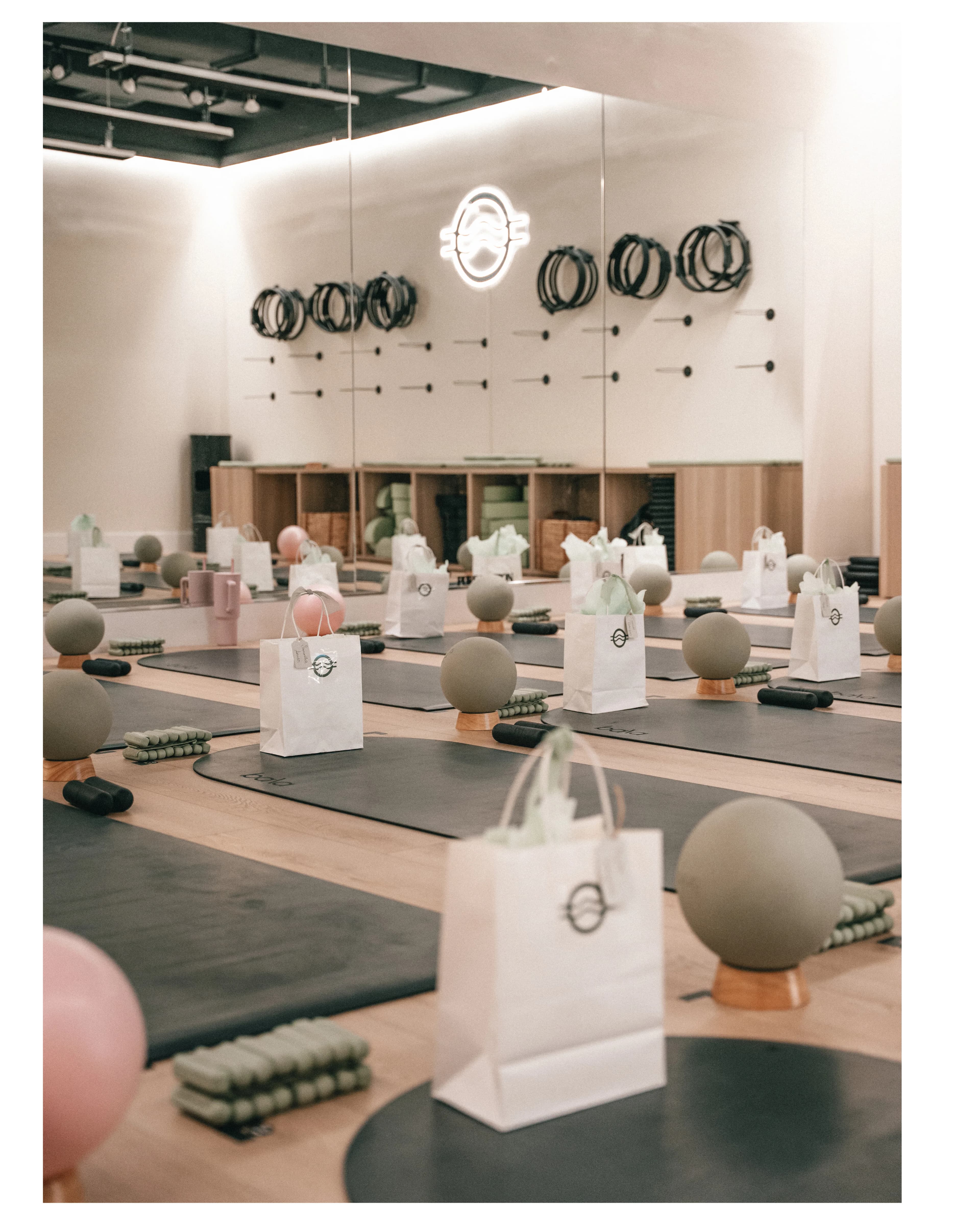 A styled class setup with mats, gift bags, and decor for a Pure Motion event.