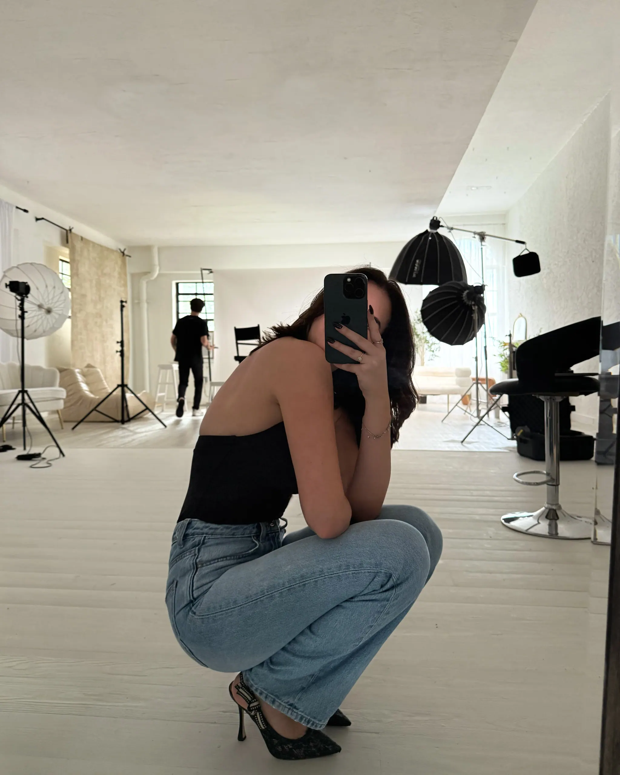 Liz taking a mirror selfie during a Blank Marketing Group studio shoot.